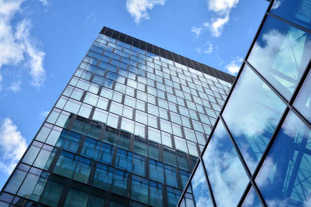 Facade texture of a glass mirrored office building. Fragment of the facade. Modern architecture of the office building.のeditorial素材
