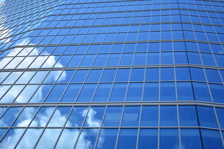 Facade texture of a glass mirrored office building. Fragment of the facade. Modern architecture of the office building.のeditorial素材