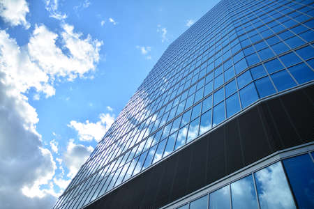 Facade texture of a glass mirrored office building. Fragment of the facade. Modern architecture of the office building.のeditorial素材
