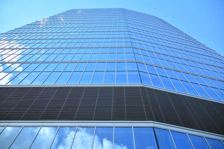 Facade texture of a glass mirrored office building. Fragment of the facade. Modern architecture of the office building.のeditorial素材