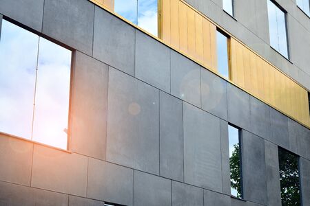 Facade of a modern apartment building. Surface with sunlight.の写真素材