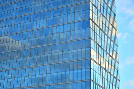 Facade texture of a glass mirrored office building. Fragment of the facade. Modern architecture of...