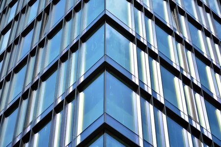 Facade texture of a glass mirrored office building. Fragment of the facade. Modern architecture of the office building.の写真素材