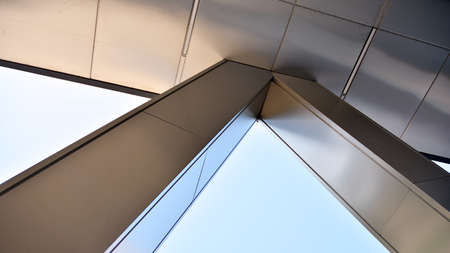 Combination of metal and glass wall material. Steel facade on columns. Abstract modern architecture. High-tech minimalist office building. Contemporary business architecture abstract fragment.の写真素材