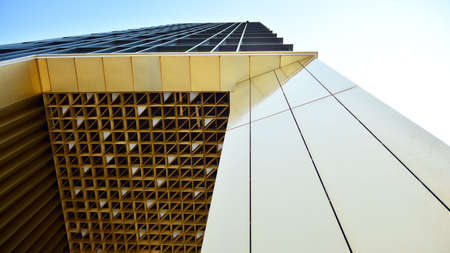 Combination of metal and glass wall material. Steel facade on columns. Abstract modern architecture....