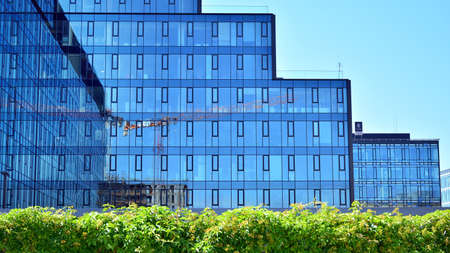 Facade texture of a glass mirrored office building. Fragment of the facade. Modern architecture of...