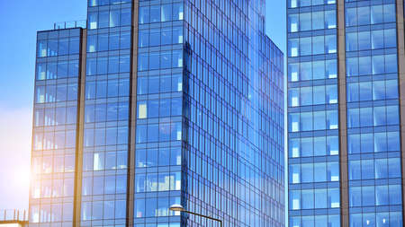 Facade texture of a glass mirrored office building. Fragment of the facade. Bottom view of modern...