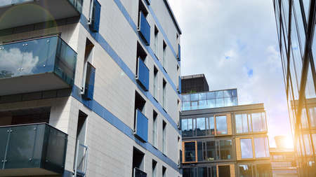 Modern apartment buildings on a sunny day with a blue sky. Facade of a modern apartment building....