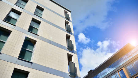 Modern apartment buildings on a sunny day with a blue sky. Facade of a modern apartment building....