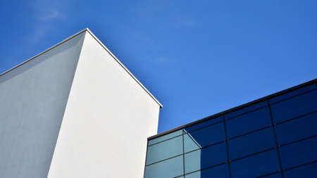 Abstract image of looking up at modern glass and concrete building. Architectural exterior detail of...