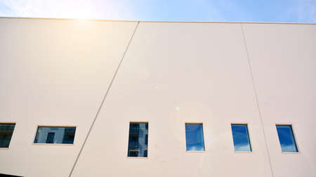Abstract image of looking up at modern glass and concrete building. Architectural exterior detail of...