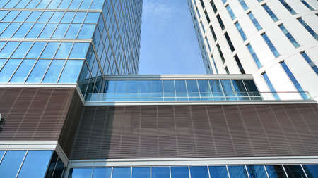 Bottom view of glass silhouette of skyscraper. Business building. Skyscraper with glass facade....