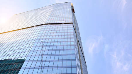 Bottom view of glass silhouette of skyscraper. Business building. Skyscraper with glass facade....