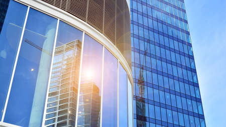 Bottom view of glass silhouette of skyscraper. Business building. Skyscraper with glass facade. Modern building in business district. Concepts of economics, financial, future.の写真素材