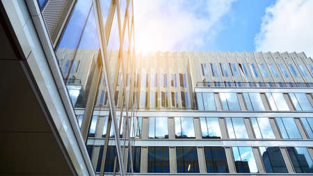 Office building, details of blue glass wall and sun reflections.の写真素材