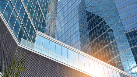 Office building, details of blue glass wall and sun reflections.