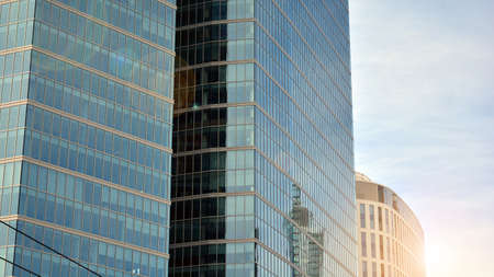 Office building, details of blue glass wall and sun reflections.