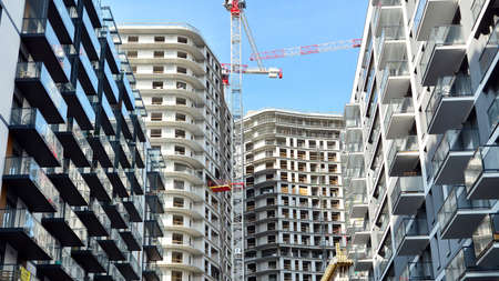 Crane and building under construction against blue sky