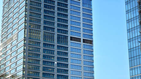 Facade texture of a glass mirrored office building. Fragment of the facade. Modern architecture of the office building.の写真素材