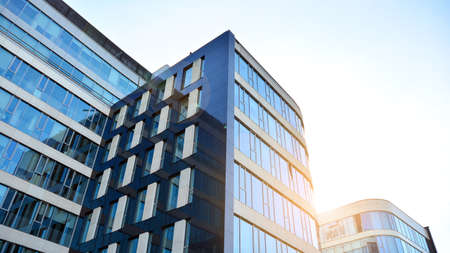 Office building, details of blue glass wall and sun reflections.の写真素材