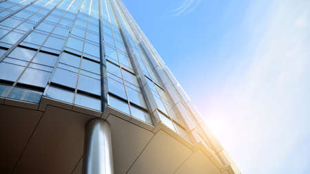Office building, details of blue glass wall and sun reflections.