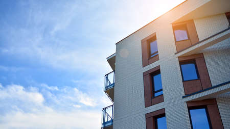 Apartment residential house and home facade architecture and outdoor facilities. Blue sky on the background. Sunlightの写真素材