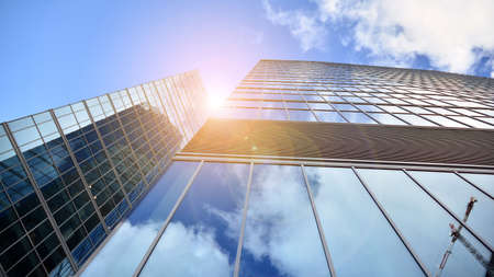 Bottom view of modern office buildings in the business district. Skyscraper glass facades on a...