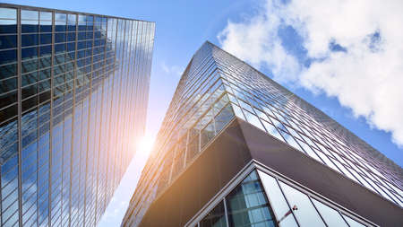 Bottom view of modern office buildings in the business district. Skyscraper glass facades on a...