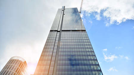 Bottom view of modern office buildings in the business district. Skyscraper glass facades on a...