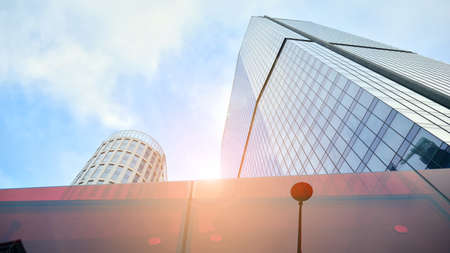 Bottom view of modern office buildings in the business district. Skyscraper glass facades on a...