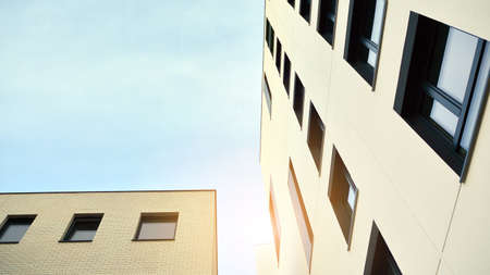 Modern apartment buildings on a sunny day with a blue sky. Facade of a modern apartment building....