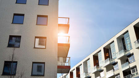 Modern apartment buildings on a sunny day with a blue sky. Facade of a modern apartment building....