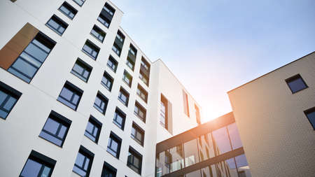Modern apartment buildings on a sunny day with a blue sky. Facade of a modern apartment building. Glass surface with sunlight.の写真素材