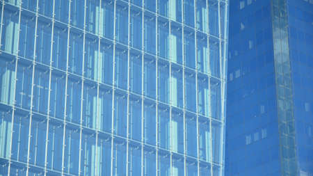 Facade texture of a glass mirrored office building. Fragment of the facade. Modern architecture of...