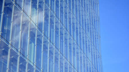 Facade texture of a glass mirrored office building. Fragment of the facade. Modern architecture of...
