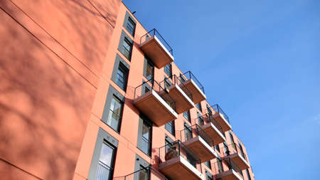 Colorful modern residential building. New luxury house and home complex of red color. City Real...