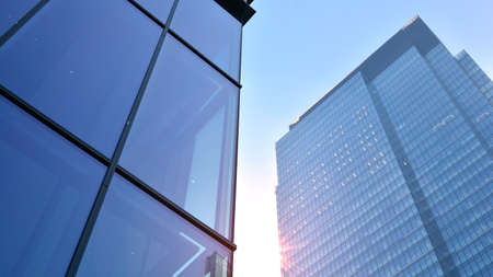 Concept for real estate and corporate construction..The modern office building of the orange morning...