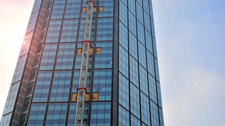 Concept for real estate and corporate construction..The modern office building of the orange morning...