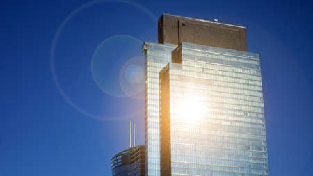 Downtown corporate business district architecture. Glass reflective office buildings against blue...