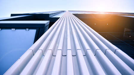 Downtown corporate business district architecture. Glass reflective office buildings against blue sky and sun light. Economy, finances, business activity concept.の写真素材