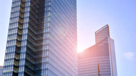 Downtown corporate business district architecture. Glass reflective office buildings against blue...
