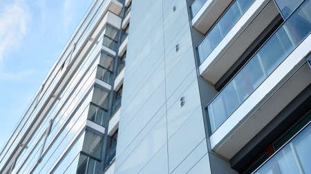 Condominium and apartment building with symmetrical modern architecture in the city downtown.