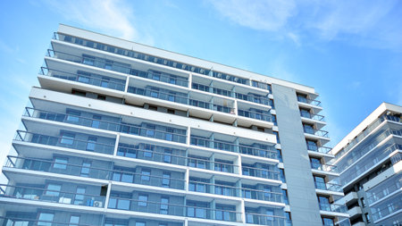 Condominium and apartment building with symmetrical modern architecture in the city downtown.の写真素材