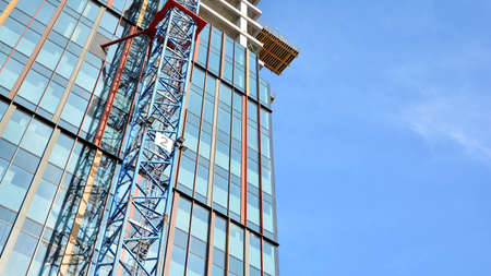 View of a skyscraper under construction. Modern architecture background. Building a high-rise...