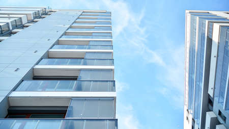 Condominium and apartment building with symmetrical modern architecture in the city downtown.