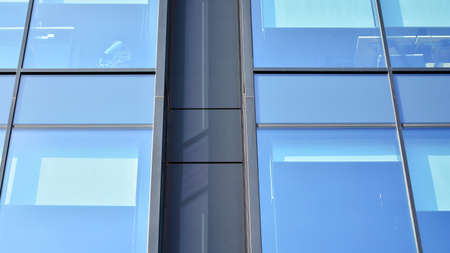 Fragment of glass and metal facade walls. Commercial office buildings. Abstract modern business...
