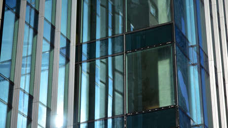 Fragment of glass and metal facade walls. Commercial office buildings. Abstract modern business...