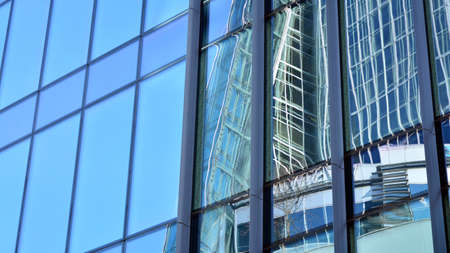 Fragment of glass and metal facade walls. Commercial office buildings. Abstract modern business...