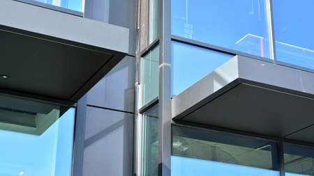 Fragment of glass and metal facade walls. Commercial office buildings. Abstract modern business...