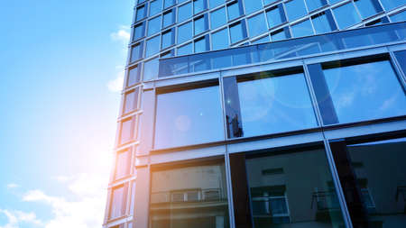 Abstract closeup of the glass-clad facade of a modern building covered in reflective plate glass....